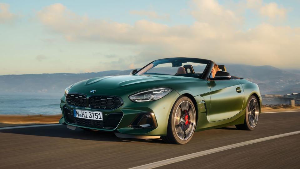 a green sports car on a road