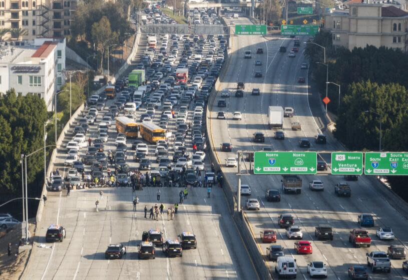 LOS ANGELES, CA - DECEMBER 13: American Jews and allies block the 110 freeway in downtown on Wednesday, Dec. 13, 2023 in Los Angeles, CA to call for an Israeli ceasefire. (Myung J. Chun / Los Angeles Times)