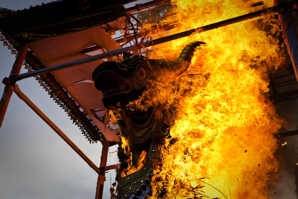 UBUD, BALI, INDONESIA - AUGUST 18: A black bull sarcophagus is set on fire during the Hindu Royal cremation of Anak Agung Rai Niang - also know as the Pengabenan - for the late Anak Agung Niang Rai, mother of Gianyar Regent, Tjokorda Oka Artha Ardana Sukawati, at Puri Ubud in Gianyar Bali on August 18, 2011 in Ubud, Bali, Indonesia. Niang Rai died in a Denpasar hospital in May; and will involve a nine level, 24m high 'bade' or body carring tower, made by upto 100 volunteers from 14 local villages. It will be carried to the cremation by 4500 Ubud residents. (Photo by Ulet Ifansasti/Getty Images)