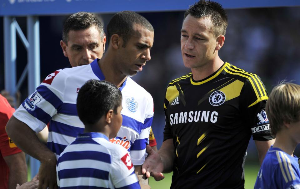 Queens Park Rangers' English defender Anton Ferdinand (L) avoids shaking hands with Chelsea's English defender John Terry - AFP PHOTO/GLYN KIRK