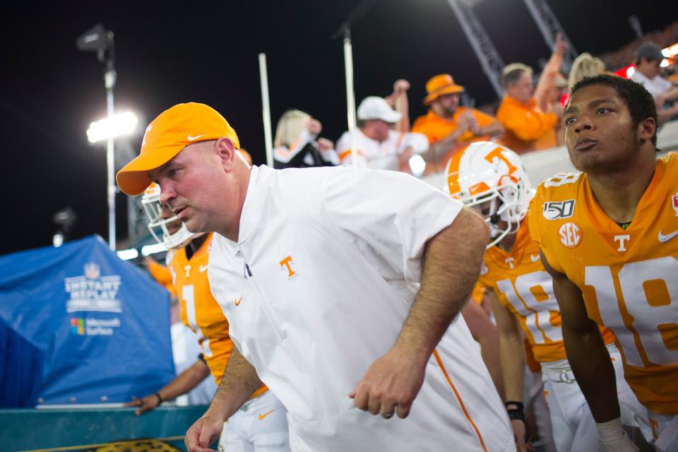 Tennessee football coach Jeremy Pruitt runs onto the field Jan. 2, 2020, before the Gator Bowl featuring Tennessee and Indiana at TIAA Bank Field in Jacksonville, Florida.