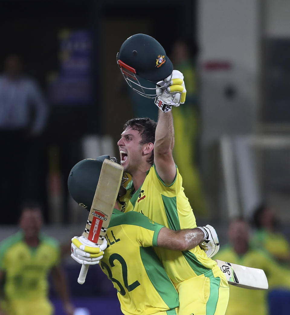 Australia's Glenn Maxwell, left, and Mitchell Marsh celebrate after winning the Cricket Twenty20 World Cup final match between New Zealand and Australia in Dubai, UAE, Sunday, Nov. 14, 2021. (AP Photo/Aijaz Rahi)