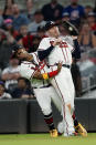 Atlanta Braves first baseman Freddie Freeman, right, collides with right fielder Ronald Acuna Jr. as he catches a fly ball from Boston Red Sox's Hunter Renfroe during the seventh inning of a baseball game Wednesday, June 16, 2021, in Atlanta. (AP Photo/John Bazemore)