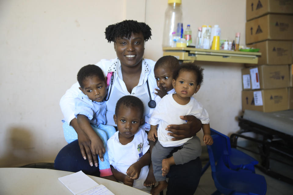 Dr. Michel Jovania poses for a portrait with young patients at a malnutrition stabilization center at the Fontaine Hospital Center in the Cité Soleil area of Port-au-Prince, Haiti, Monday, Jan. 23, 2023. As gangs tighten their grip on Haiti, many medical facilities in the Caribbean nation's most violent areas have closed, leaving Fontaine as one of the last hospitals and social institutions in one of the world's most lawless places. (AP Photo/Odelyn Joseph)