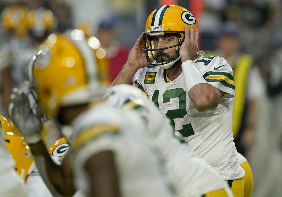 Green Bay Packers quarterback Aaron Rodgers (12) changes a call against the Arizona Cardinals in the first half of an NFL football game Thursday, Oct. 28, 2021, in Glendale, Ariz. (AP Photo/Darryl Webb)