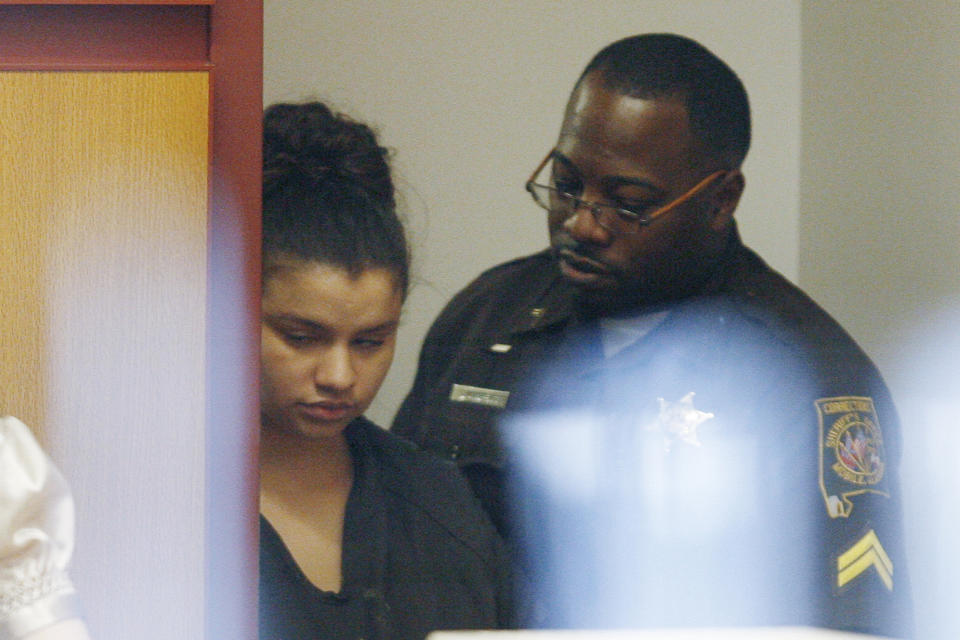 FILE - Heather Leavell-Keaton, 22, left, is led into the courtroom by a sheriff's deputy as she appears for a bail hearing in Mobile County District Court, Dec. 14, 2010, in Mobile, Ala. The Supreme Court is leaving in place the sentence of a woman on death row in Alabama who helped her boyfriend kill his two young children.The high court rejected an appeal from lawyers for Heather Leavell-Keaton on Monday. (AP Photo/Press-Register, Mike Kittrell, File)