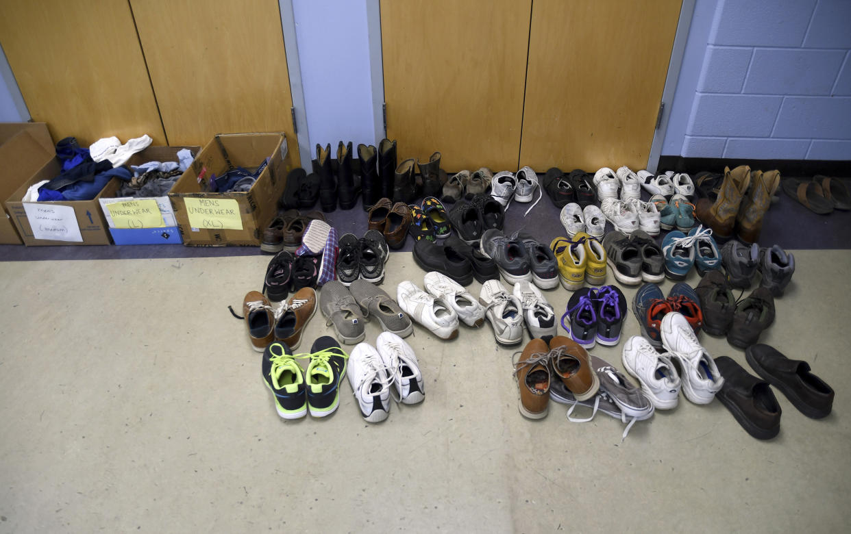 Donated shoes are organized at a makeshift shelter in Denver, Friday, Jan. 6, 2023. Over the past month, nearly 4,000 immigrants, almost all Venezuelans, have arrived unannounced in the frigid city, with nowhere to stay and sometimes wearing T-shirts and flip-flops. In response, Denver converted three recreation centers into emergency shelters for migrants and paid for families with children to stay at hotels, allocating $3 million to deal with the influx. (AP Photo/Thomas Peipert)