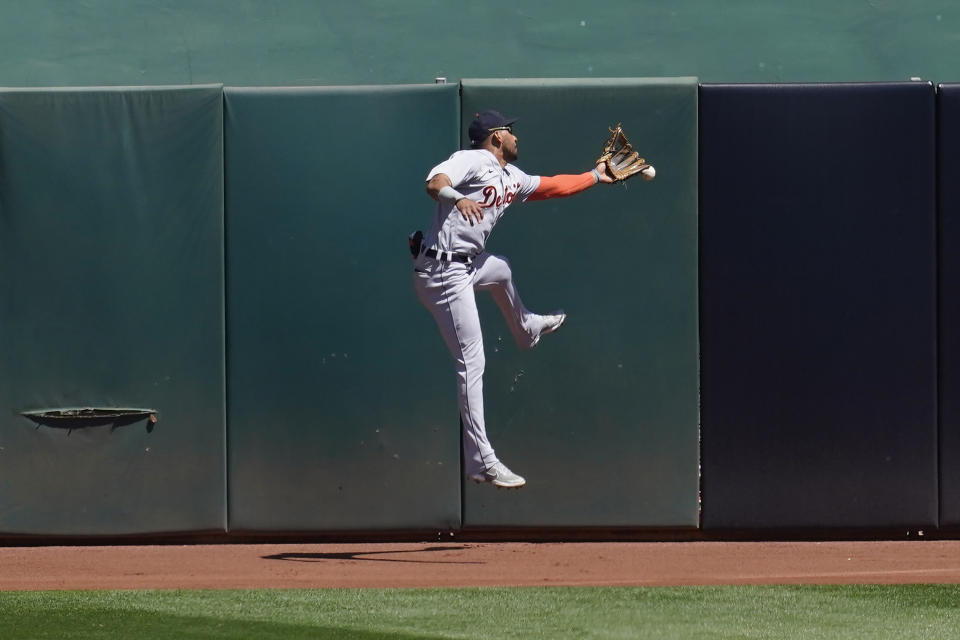 Detroit Tigers center fielder Victor Reyes cannot catch a run-scoring triple hit by Oakland Athletics' Ramon Laureano during the fourth inning of a baseball game in Oakland, Calif., Sunday, April 18, 2021. (AP Photo/Jeff Chiu)