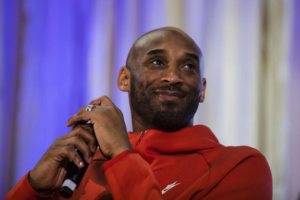 Former Los Angeles Lakers NBA basketball player Kobe Bryant listens to a question as he meets with students at Andrew Hamilton School in Philadelphia, Thursday, March 21, 2019. Kobe Bryant was promoting the book The Wizenard Series: Training Camp he created with writer Wesley King. (AP Photo/Matt Rourke)