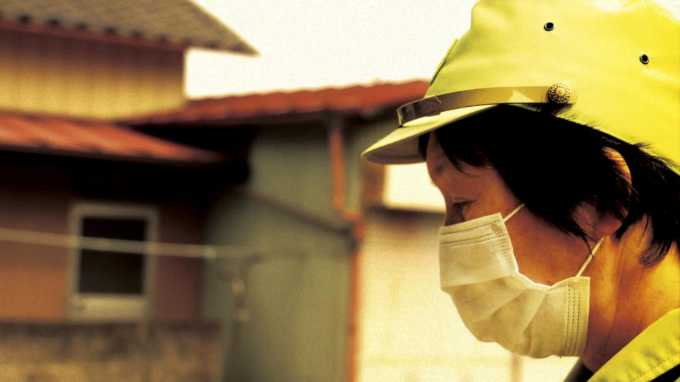 In this image made from a scene from the film “Fukushima: Memories of the Lost Landscape" released by Yojyu Matsubayashi, Kyoko Tanaka, a city council member of Minami Soma, patrols in the deserted town after evacuation of the residents, on April 3, 2011. Japanese film director Matsubayashi took a more standard documentary approach for his “Fukushima: Memories of the Lost Landscape,” interviewing people who were displaced in the Fukushima town of Minami Soma. He followed them into temporary shelters in cluttered gymnasiums and accompanied their harried visits to abandoned homes with the gentle patience of a video-journalist. The March 2011 catastrophe in Japan has set off a flurry of independent films telling the stories of regular people who became overnight victims, stories the creators feel are being ignored by mainstream media and often silenced by the authorities. (AP Photo/Yojyu Matsubayashi) MANDATORY CREDIT, EDITORIAL USE ONLY