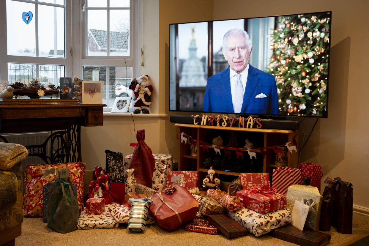 return gifts Above unopened Christmas presents, King Charles gives his first Christmas broadcast as monarch on a widescreen TV screen in the living room of a family home, after his coronation in May, on 25th December 2023, in Nailsea, England. (Photo by Richard Baker / In Pictures via Getty Images)