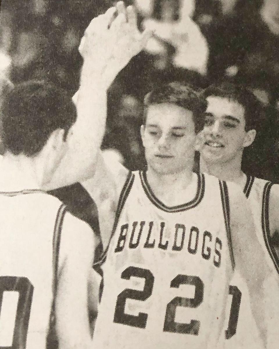 De Smet's Buster Vincent (22) is congratulated by teammates Josh Pommer (left) and Mark Wilkinson after he hitting game-winning free throws in the 1996 District 3A boys basketball championship.