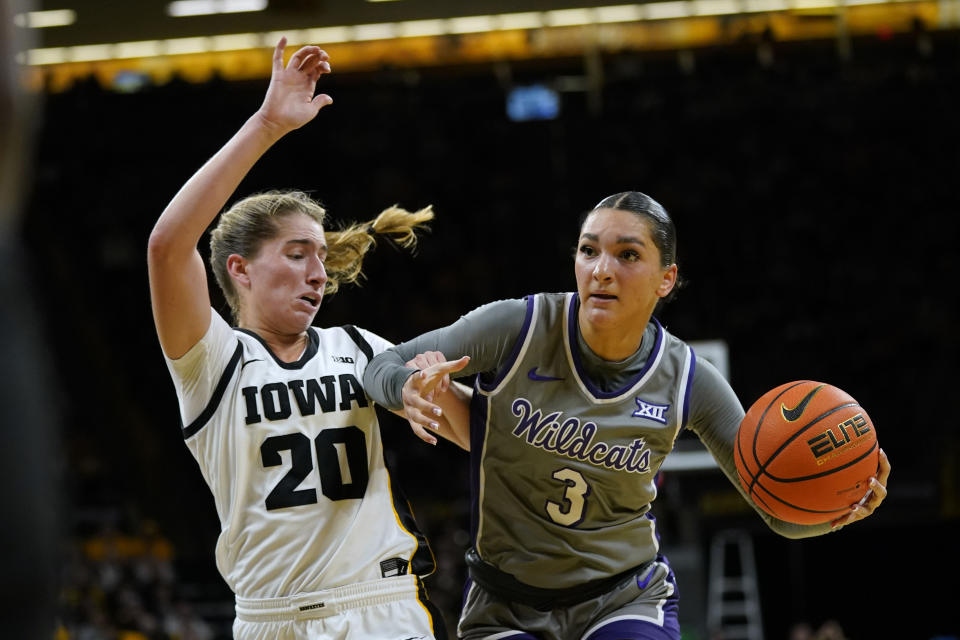 Kansas State guard Jaelyn Glenn (3) drives past Iowa guard Kate Martin (20) during the first half of an NCAA college basketball game, Thursday, Nov. 16, 2023, in Iowa City, Iowa. (AP Photo/Charlie Neibergall)