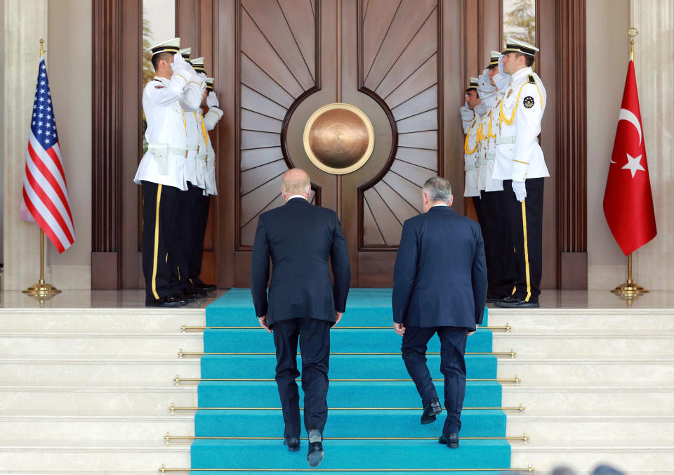 Biden and Yildirim walk to review a guard of honor