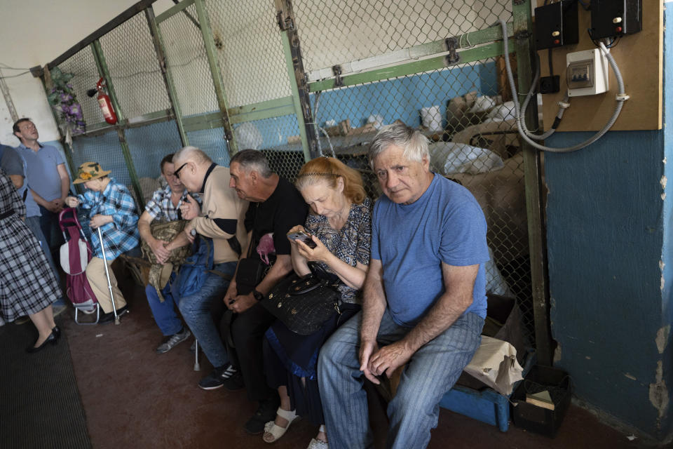 People sit in a workshop in Kyiv, Ukraine, May 30, 2023, in a manufacturing plant where visually impaired people used to work until it was shuttered following a Russian air assault. Losing the place of work is just one of a multitude of challenges that people with visual impairments face across Ukraine since Russia launched a full-scale invasion in February 2022. (AP Photo/Roman Hrytsyna)