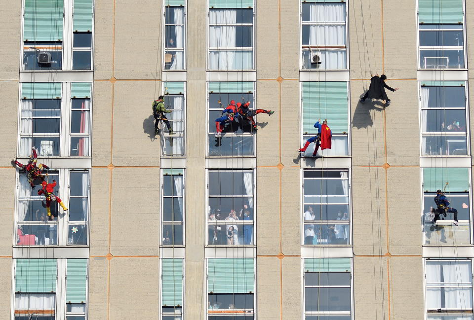 Acrobatic superheroes greet the children hospitalised in the paediatric ward of the San Paolo hospital in Milan, Italy, December 15, 2021. REUTERS/Flavio Lo Scalzo      TPX IMAGES OF THE DAY