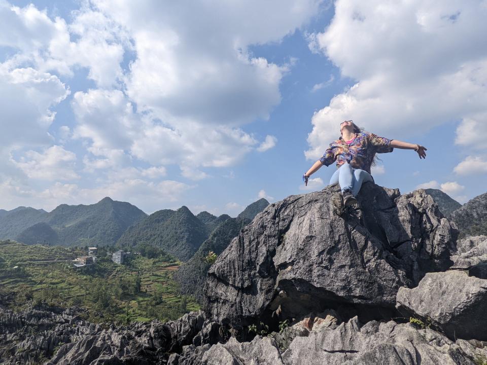 The author sitting on the edge of a cliff