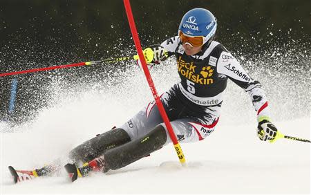 Marlies Schild of Austria clears a pole during the first run of the women's slalom at the FIS Alpine Skiing World Cup Finals in Lenzerheide March 15, 2014. REUTERS/Ruben Sprich