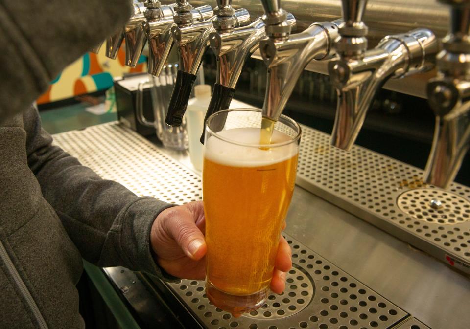 Ninkasi Brewing Company Founding Brewer Jamie Floyd pours a glass of Centennial Fresh Hop pale ale at the brewery in Eugene Ore. Sept. 15, 2020.