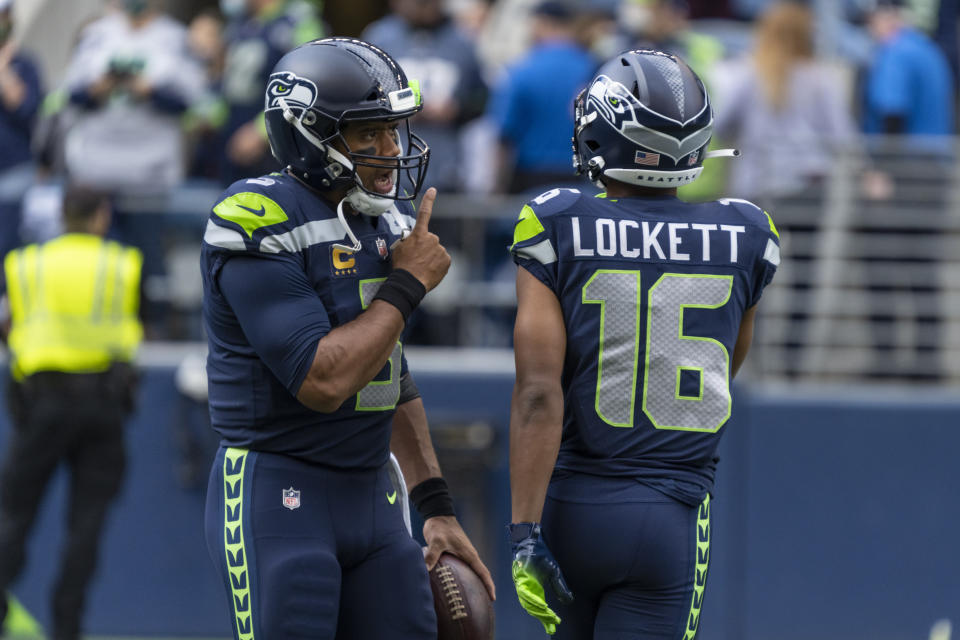 Seattle Seahawks quarterback Russell Wilson, left, greets wide receiver Tyler Lockett 