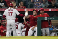 Los Angeles Angels' Shohei Ohtani (17) is met in the dugout by Mike Trout, center, and bench coach Mike Gallego, right, during the sixth inning of a baseball game against the Houston Astros Tuesday, Sept. 21, 2021, in Anaheim, Calif. (AP Photo/Marcio Jose Sanchez)