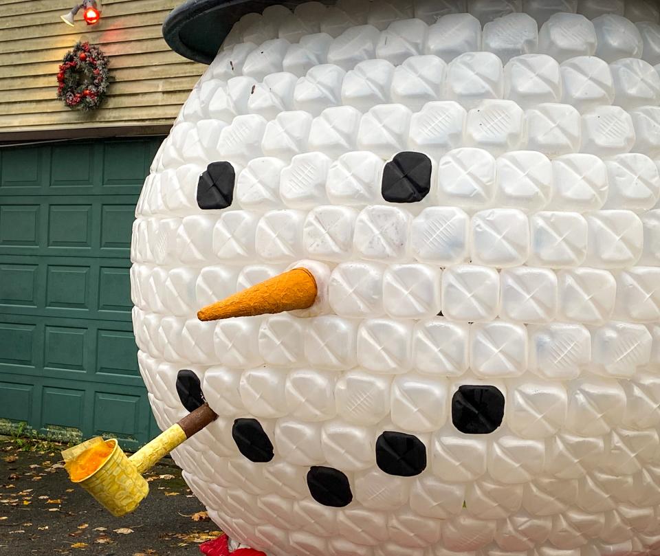 Jughead, a massive 9-foot snowman head made of nearly 800 empty gallon jugs, stands outside the house of Melissa Morgado of Somerset.