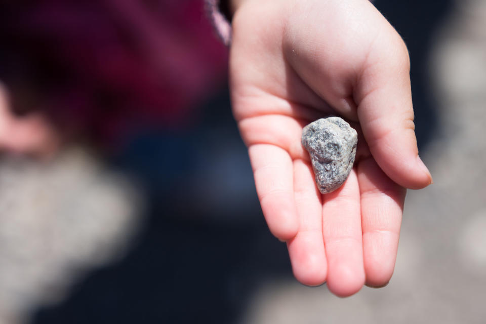 A rock in a person's hand