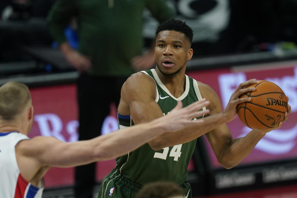 Milwaukee Bucks forward Giannis Antetokounmpo (34) looks to pass during the first half of an NBA basketball game against the Detroit Pistons, Wednesday, Jan. 13, 2021, in Detroit. (AP Photo/Carlos Osorio)