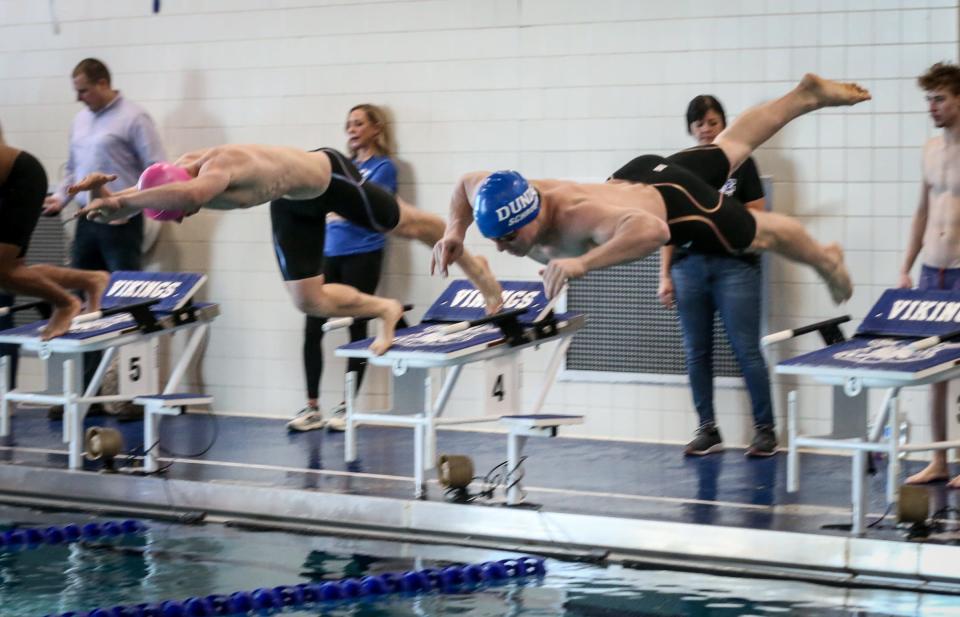 The start of the 50-yard freestyle with Dundee's Trevor Schroeder in Lane 3 (right) and Milan's Gavin Kruise in Lane 4 during the Monroe County Championship Saturday, February 4, 2023 at Dundee High School.