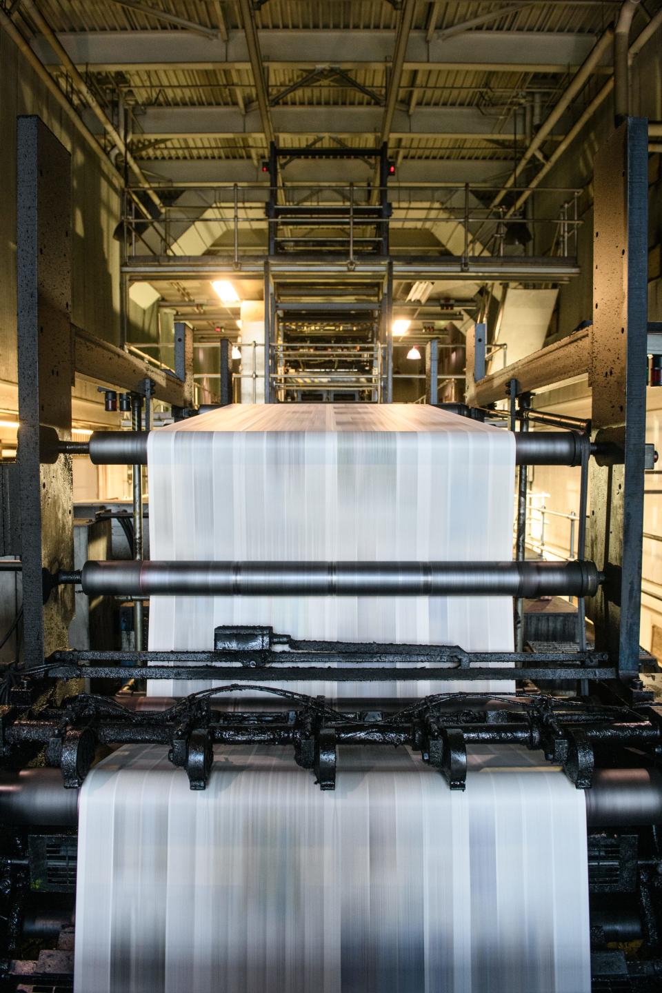 Newsprint zips by on the Koenig & Bauer AG Colora printing press at the Fayetteville Observer on Wednesday, April 5, 2023.