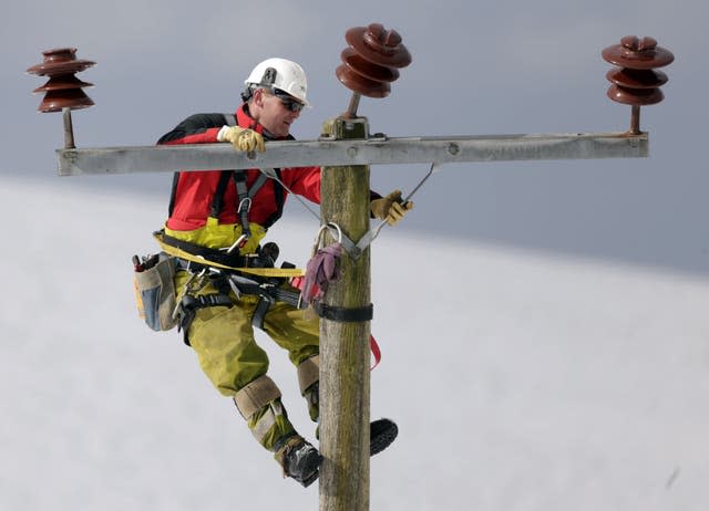Workers fix a power line 