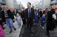 Irish Prime Minister Leo Varadkar, centre, walks with residents of Dolphin House where he officially opened phase one of a housing regeneration project in Dublin, Ireland, Friday Nov. 16, 2018. (Brian Lawless/PA via AP)