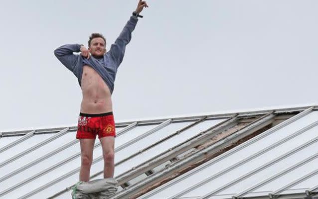 Convicted murderer Stuart Horner stripped down to his boxer shots while protesting on top of the roof of HMP Manchester. Source: Evening Standard.