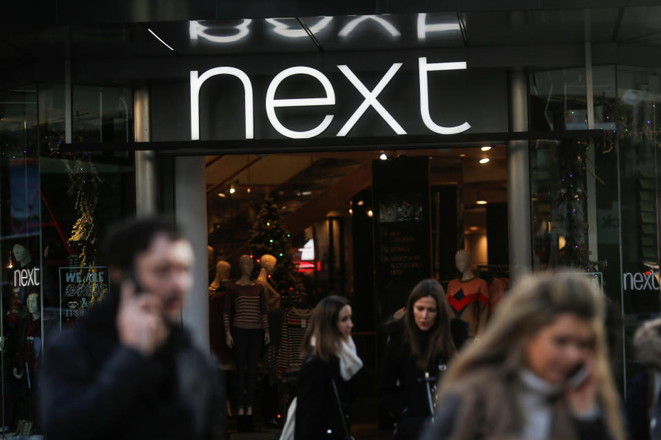 Shoppers walk past a Next store on Oxford Street in London, Britain December 17, 2018. REUTERS/Simon Dawson