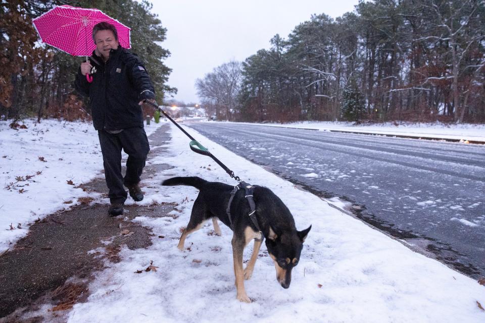 Joseph Sanchez walks his dog Callie along Ravenwood Drive in Barnegat as Callie gets her first experience with snow.