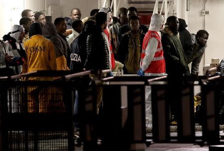 Surviving immigrants arrive by Italian coastguard ship Bruno Gregoretti in Catania's Harbour April 20, 2015. REUTERS/Alessandro Bianchi