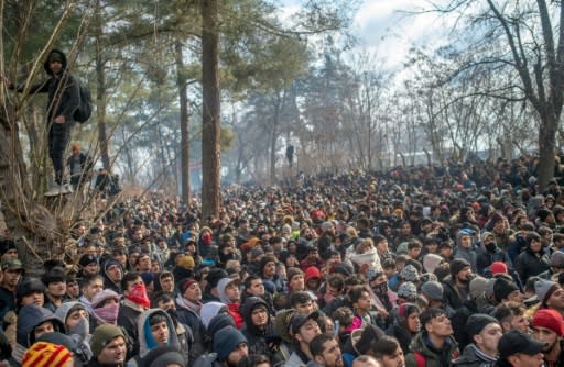 Some of the thousands of migrants gathered at the Turkish side of the border