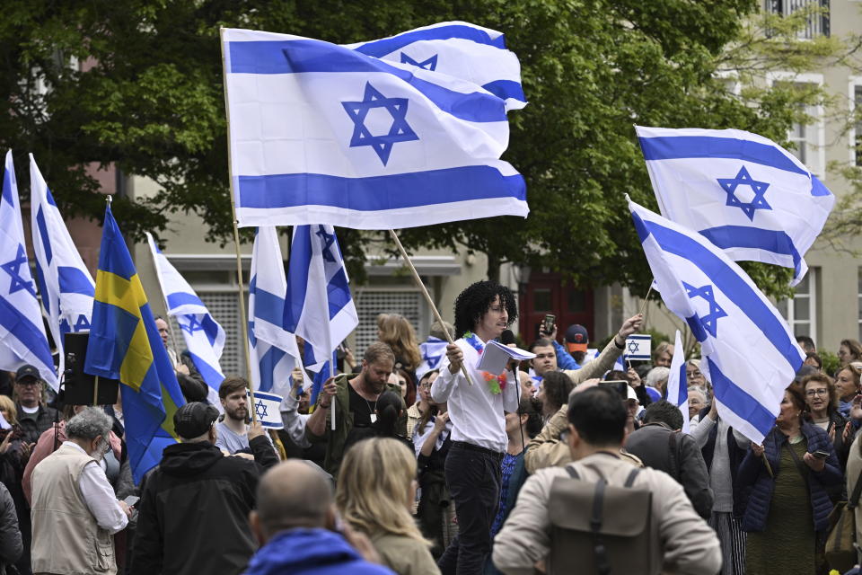 People carry Israeli and Swedish flags during a pro-Israel demonstration to pay tribute to Israel's Eurovision participant Eden Golan in Malmö, Sweden, Thursday, May 9, 2024. In addition to the pro-Israel demonstration, Stop Israel also held a demonstration targeting Israel's participation in the 68th edition of the Eurovision Song Contest (ESC) in Malmö Arena. (Johan Nilsson/TT News Agency via AP)