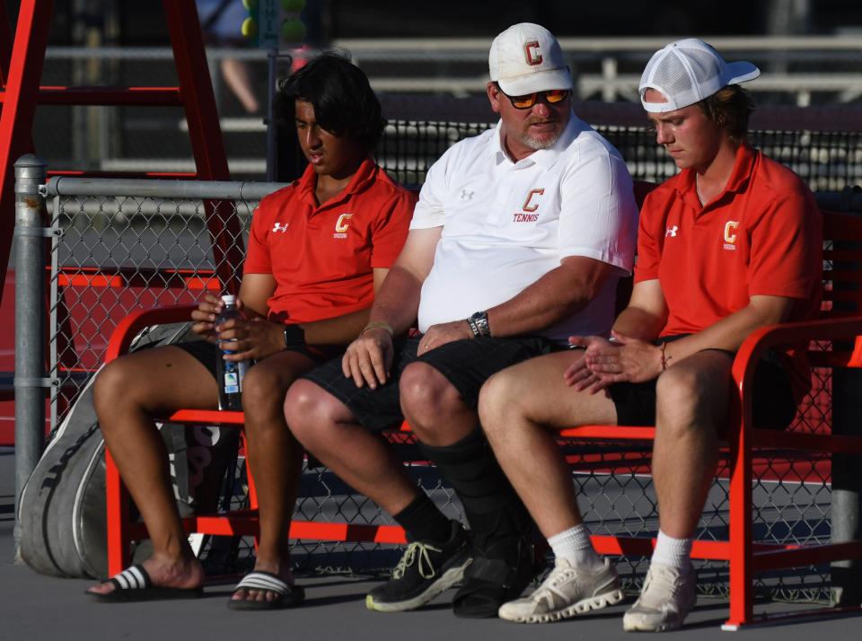 Coronado tennis coach David Denham, center, talks to Daniel Warriach, left, and Thomas Mann following a boys doubles semifinal match at the Region I-5A tournament Monday, April 10, 2023, at Texas Tech's McLeod Tennis Center.