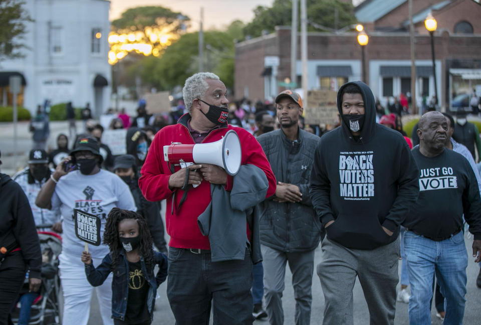 Kirk Rivers leads a group of demonstrators as they march through the streets of downtown Elizabeth City, N.C., on Friday, April 23, 2021. Several days of protests followed the shooting death of Andrew Brown Jr. on Wednesday by sheriff's deputies serving drug-related search and arrest warrants. (Robert Willett/The News & Observer via AP)