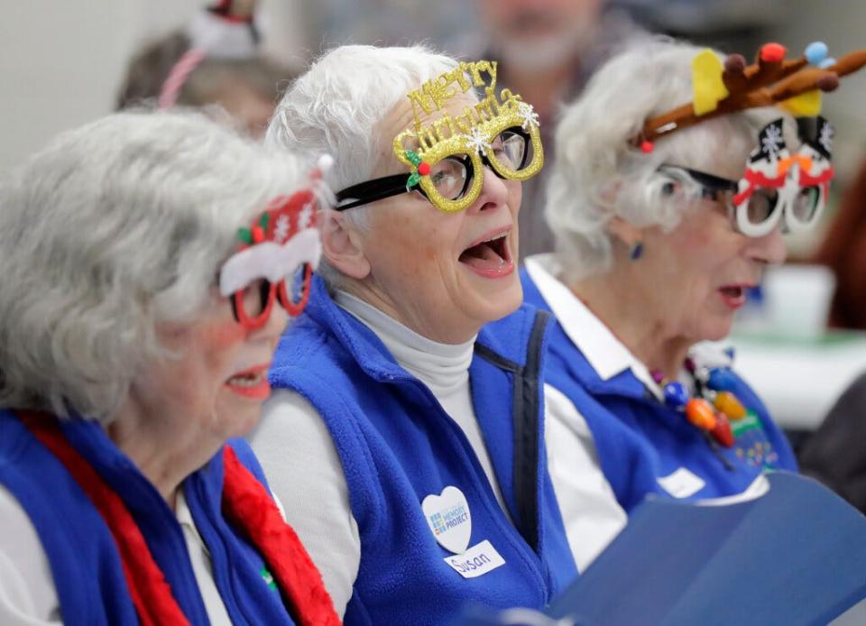 Susan McFadden, co-founder of the Fox Valley Memory Project, center, sings during an On a Positive Note Chorus performance at a memory cafe gathering Dec. 13 at the Thompson Center in Appleton.
