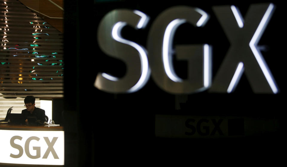 FILE PHOTO: An employee works at a front desk of the Singapore Exchange head office in Singapore April 22, 2015. REUTERS/Edgar Su/File Photo