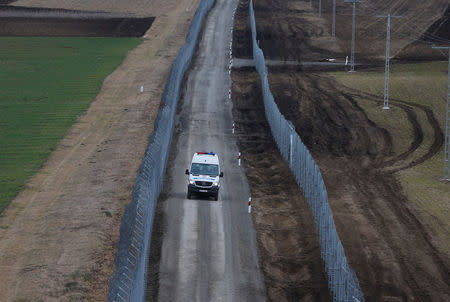 A Hungarian police van patrols the Hungary-Serbia border, which was recently fortified by a second fence, near the village of Gara, Hungary March 2, 2017. REUTERS/Laszlo Balogh