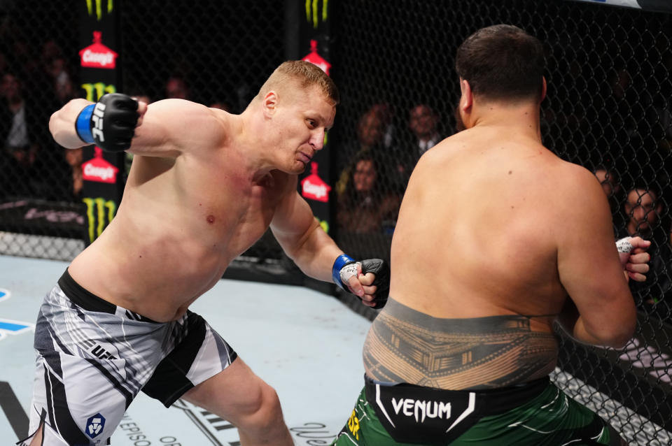 ORLANDO, FLORIDA - DECEMBER 03: (L-R) Sergei Pavlovich of Russia punches Tai Tuivasa of Australia in a heavyweight fight during the UFC Fight Night event at Amway Center on December 03, 2022 in Orlando, Florida. (Photo by Jeff Bottari/Zuffa LLC)