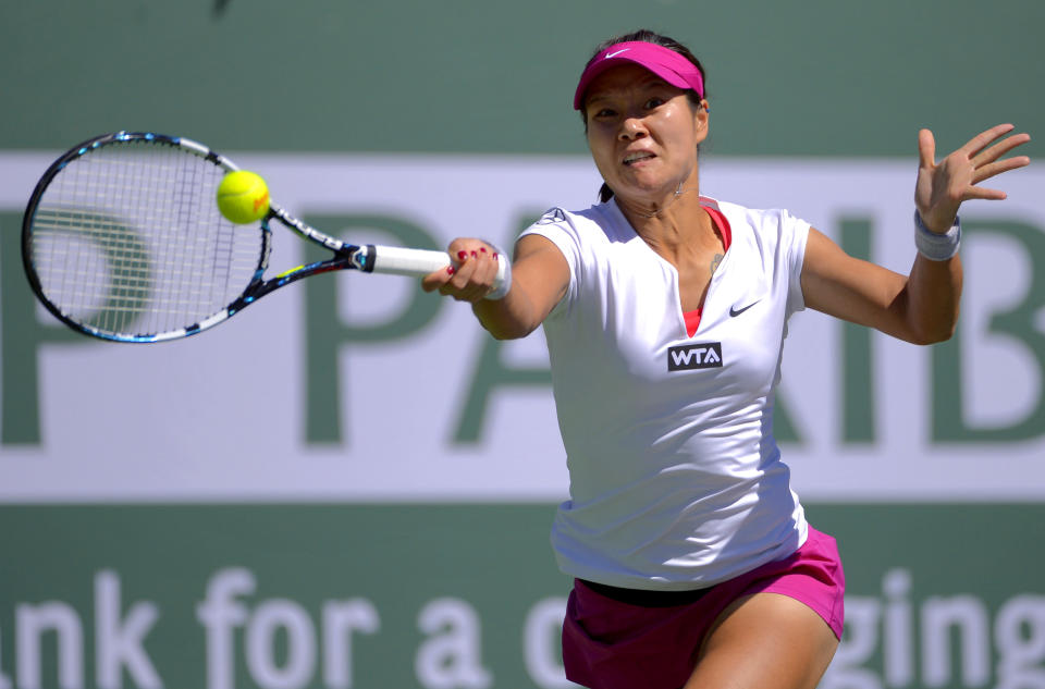 Li Na, of China, returns a volley by Karolina Pliskova, of the Czech Republic, during a third round match at the BNP Paribas Open tennis tournament, Monday, March 10, 2014 in Indian Wells, Calif. (AP Photo/Mark J. Terrill)