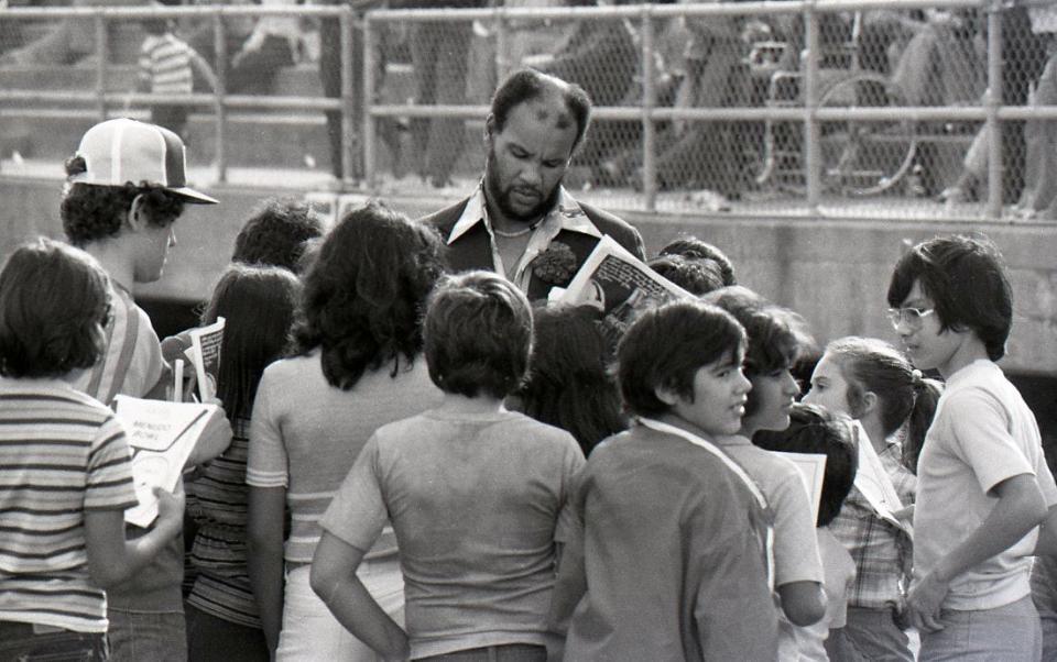 Miller grad and former NFL player and coach Johnny Roland signing autographs at the Menudo Bowl in Corpus Christi on Jan. 9, 1978.