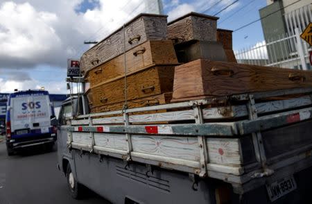 A car carrying coffins is picture in the Amazon jungle city of Manaus, Brazil, January 3, 2017. REUTERS/Ueslei Marcelino