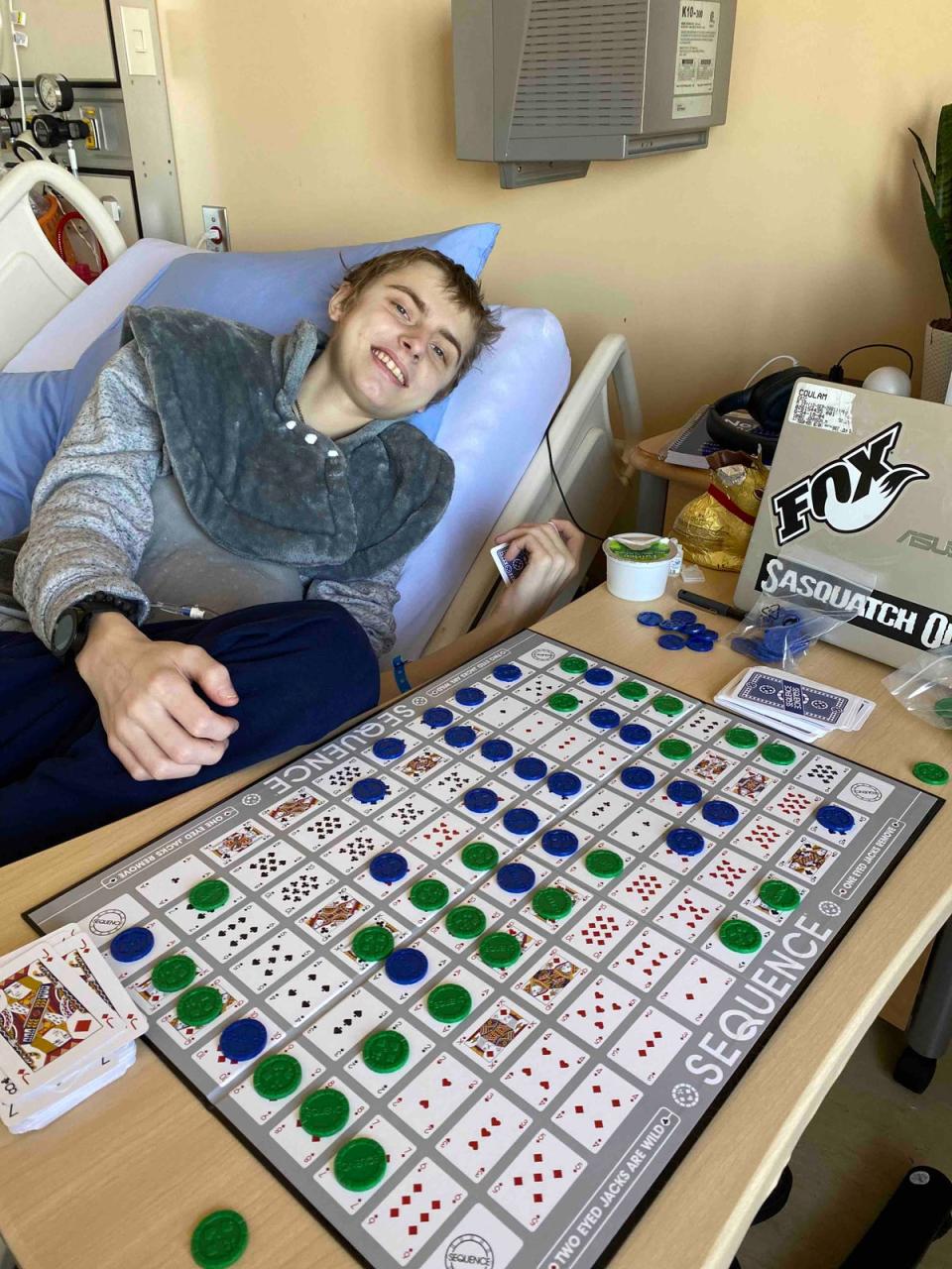 Eric Coulam plays a board game in a British Columbia hospital (GoFundMe)