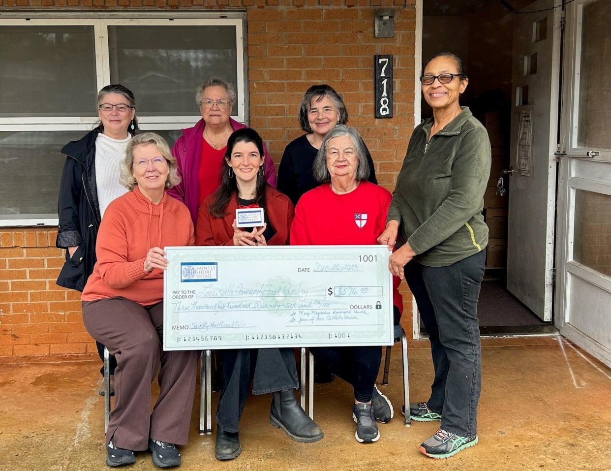 Blanche Greene (at left) and Mary Caran (center back) accept a $3,576 donation from Saintly Short Bread organizers Tish Easterlin , Lilli Agel, Pam Franklin, Lil Easterlin, and Hulet Kitterman.