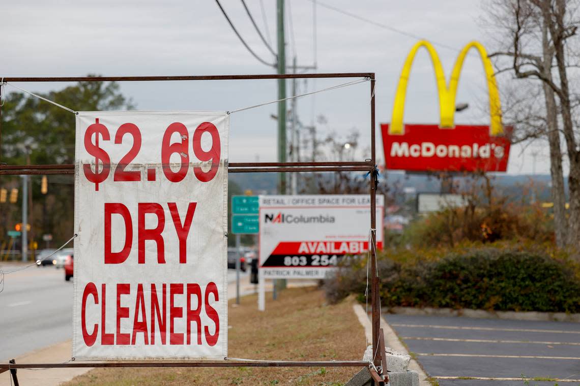 A view down Decker Boulevard in Columbia shows a sign for a dry cleaners, McDonalds and sign advertising space available. Many buildings are vacant in the area.